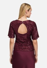Pailletten-Bluse mit Flügelärmeln / Modellfoto Rückseite